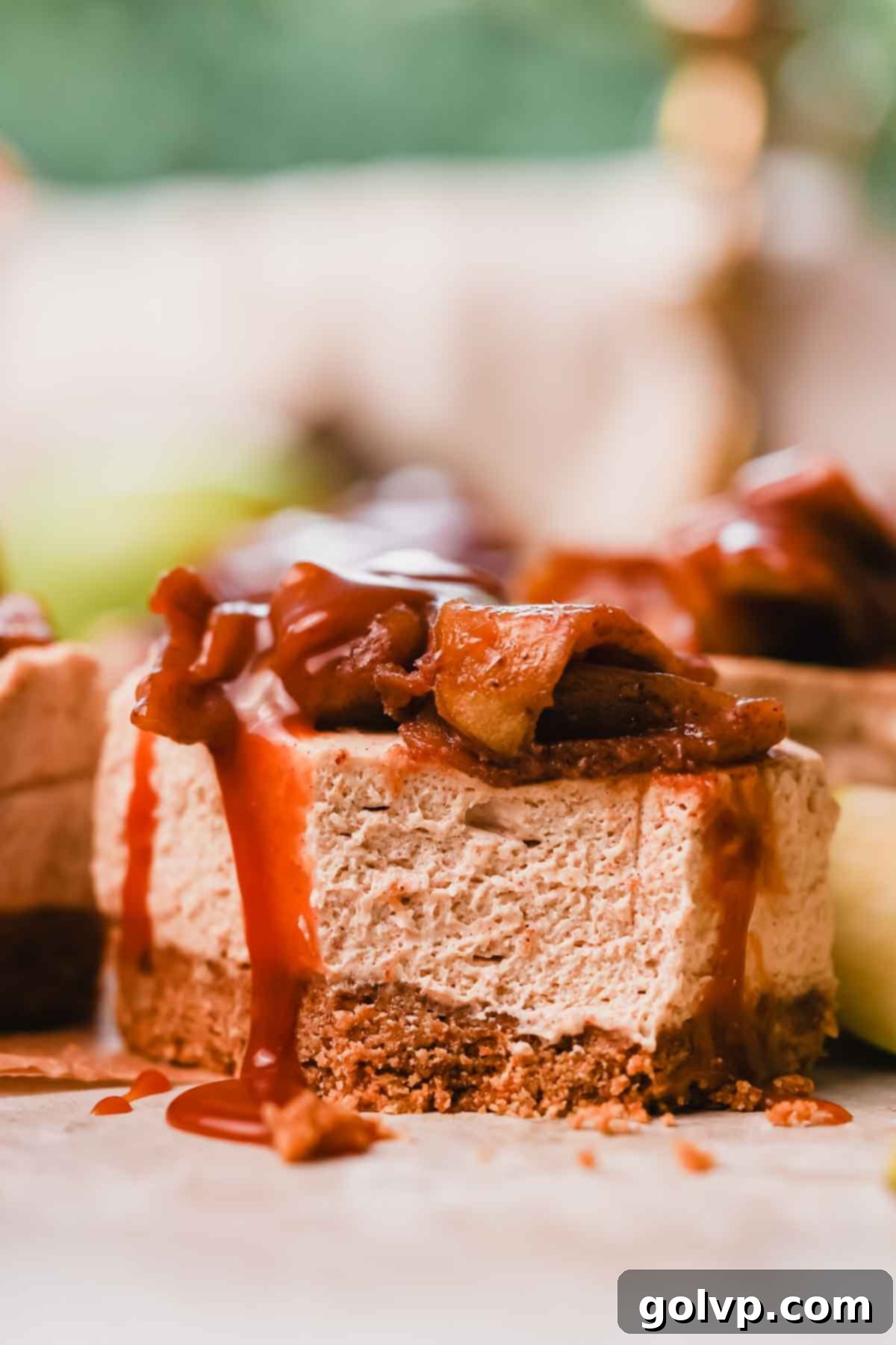 bite taken out of cheesecake bar with caramel running down the side