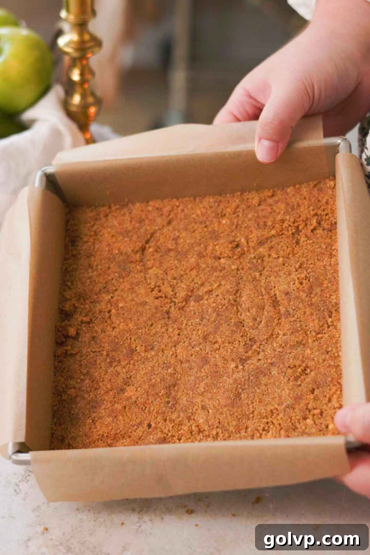 parchment lined pan with packed down graham crust