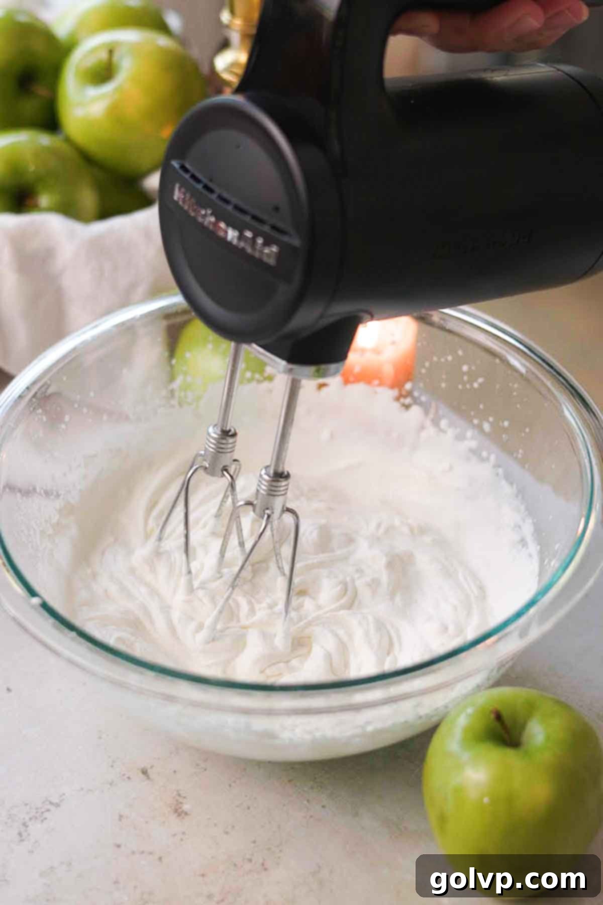 electric hand mixer whipping cream to stiff peaks