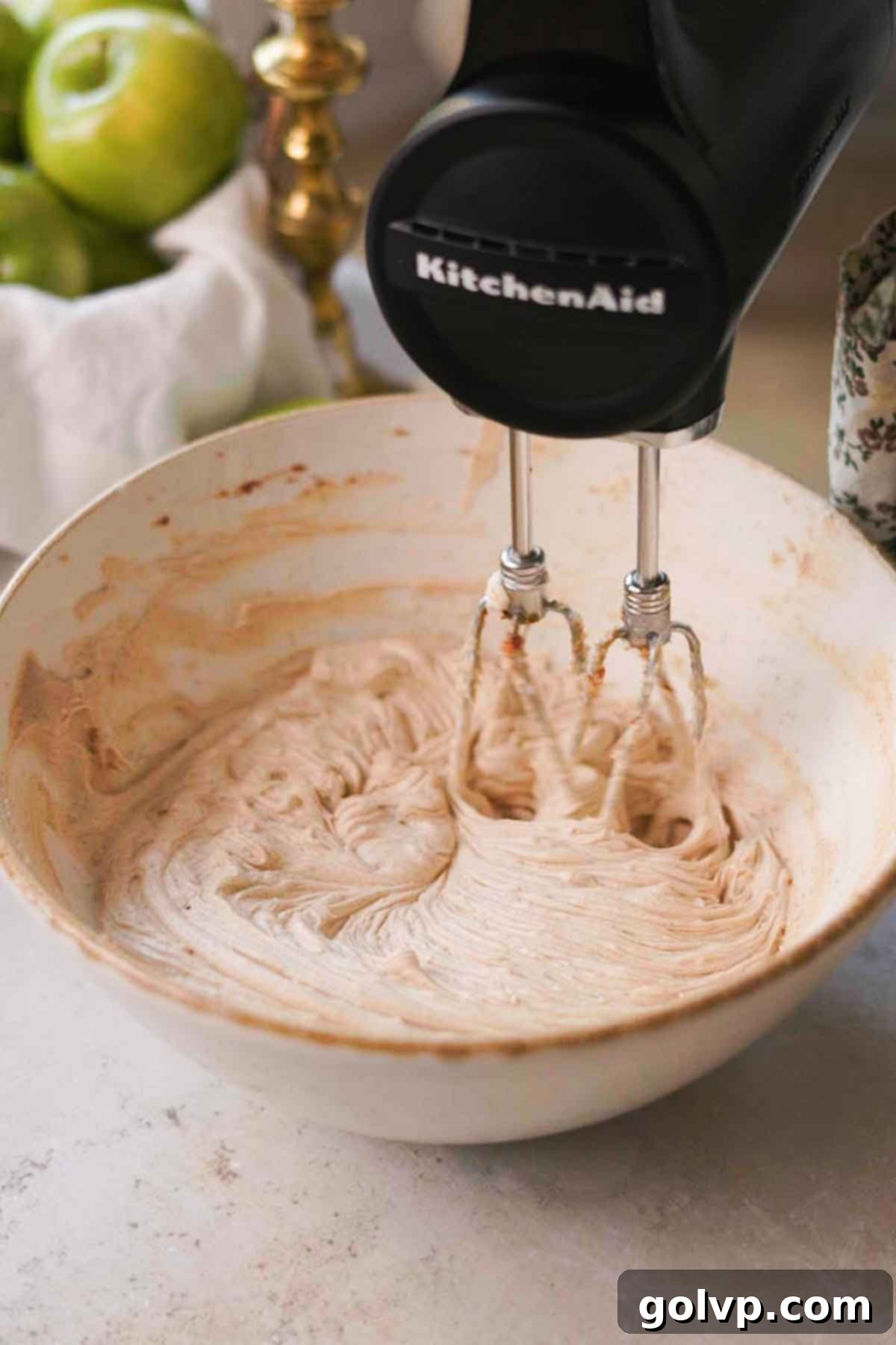 electric hand mixer whipping together cream cheese and brown sugar