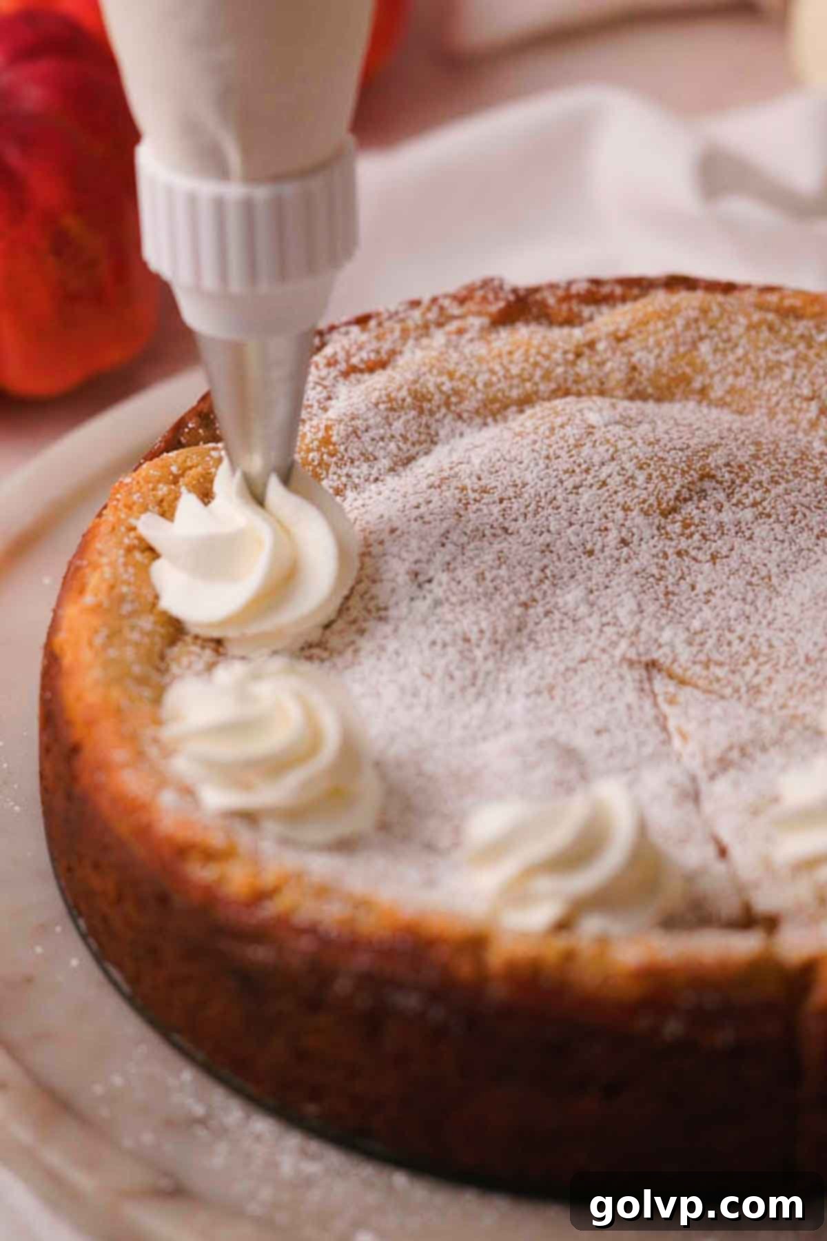 piping whipped cream onto cake