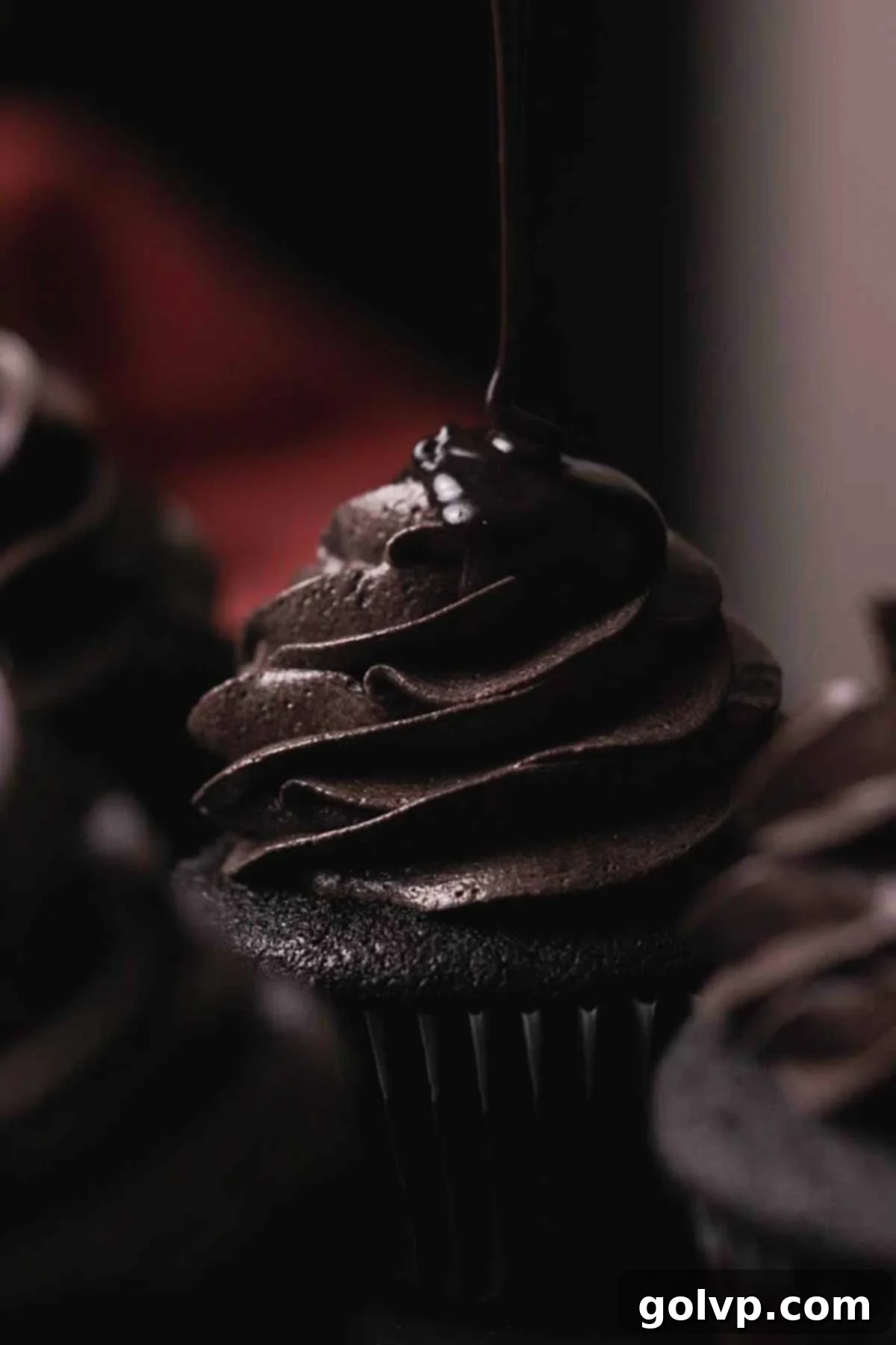 Dark Chocolate Fudge Cookies 15 drizzling on black drip onto cupcake