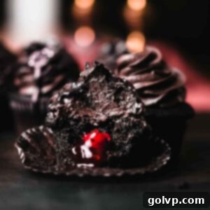 black velvet cupcake unwrapped with bite taken out