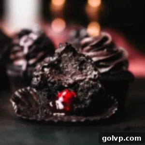 Dark Chocolate Fudge Cookies 18 black velvet cupcake unwrapped with bite taken out