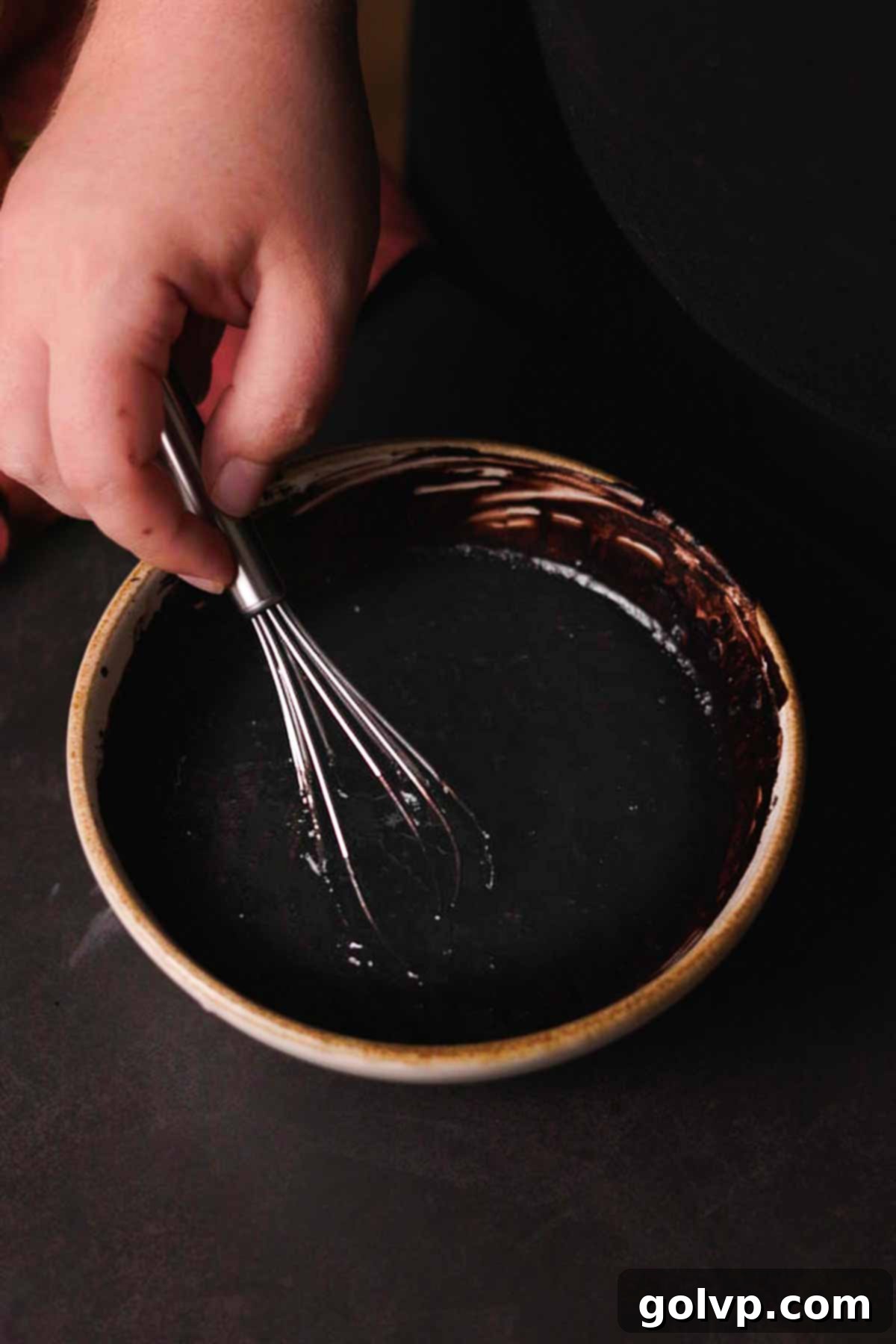 whisking hot water and black cocoa together for the cupcake batter