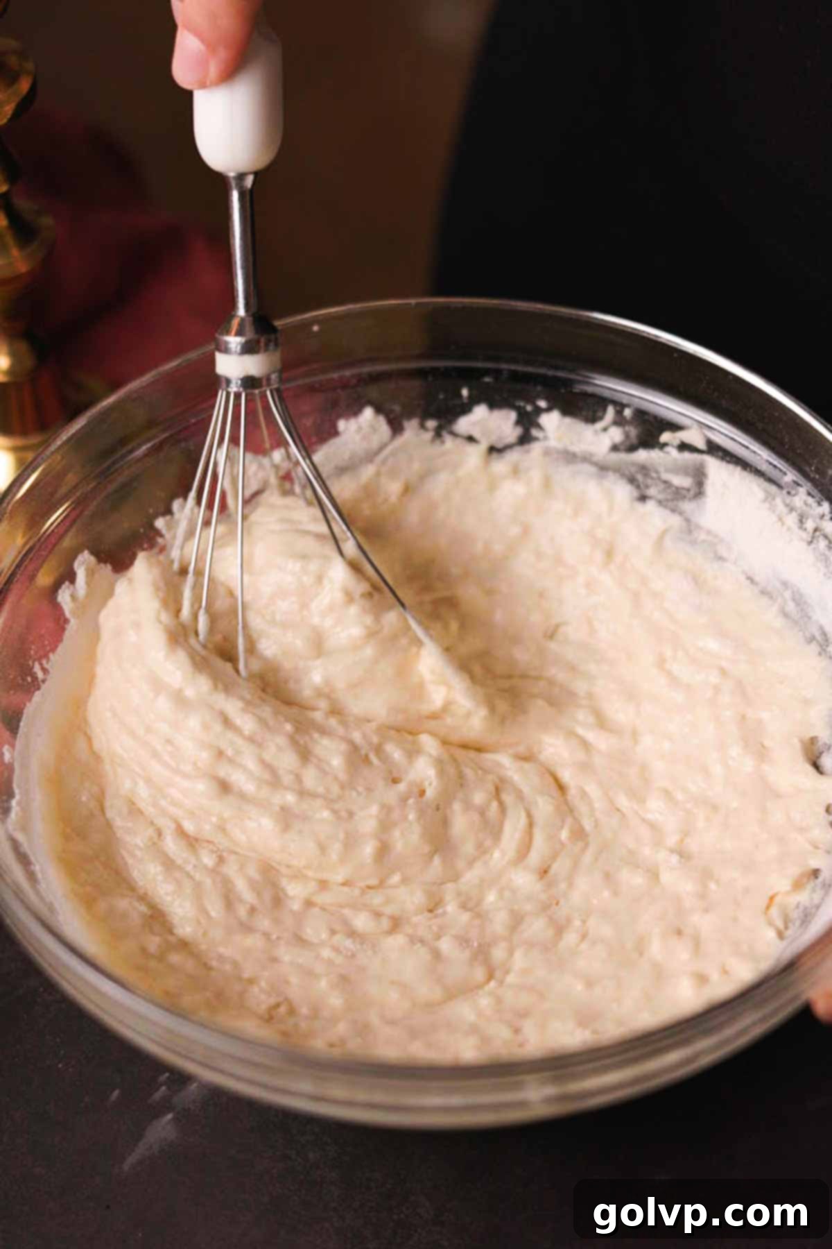 folding sifted flour into cupcake batter