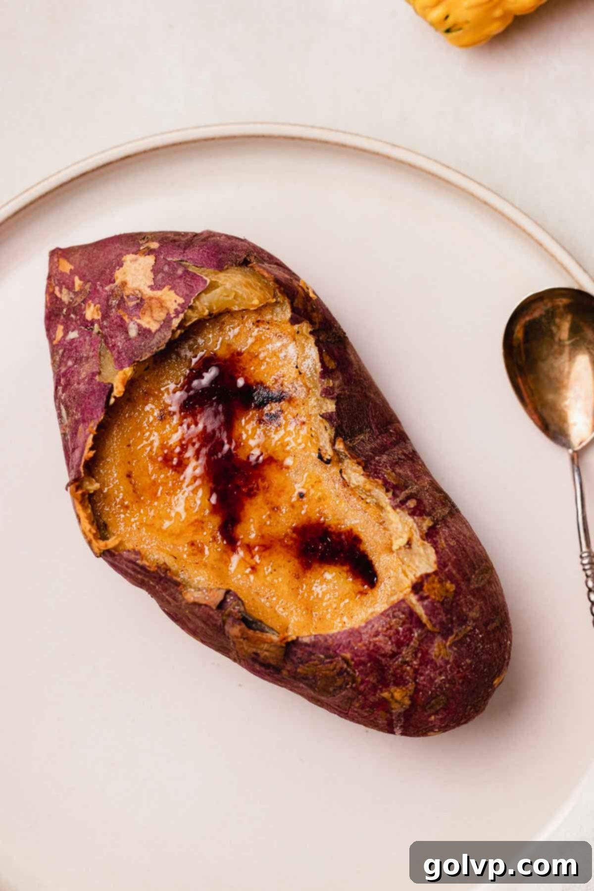 A fully assembled sweet potato crème brûlée, showcasing the golden caramelized sugar and the sweet potato shell.