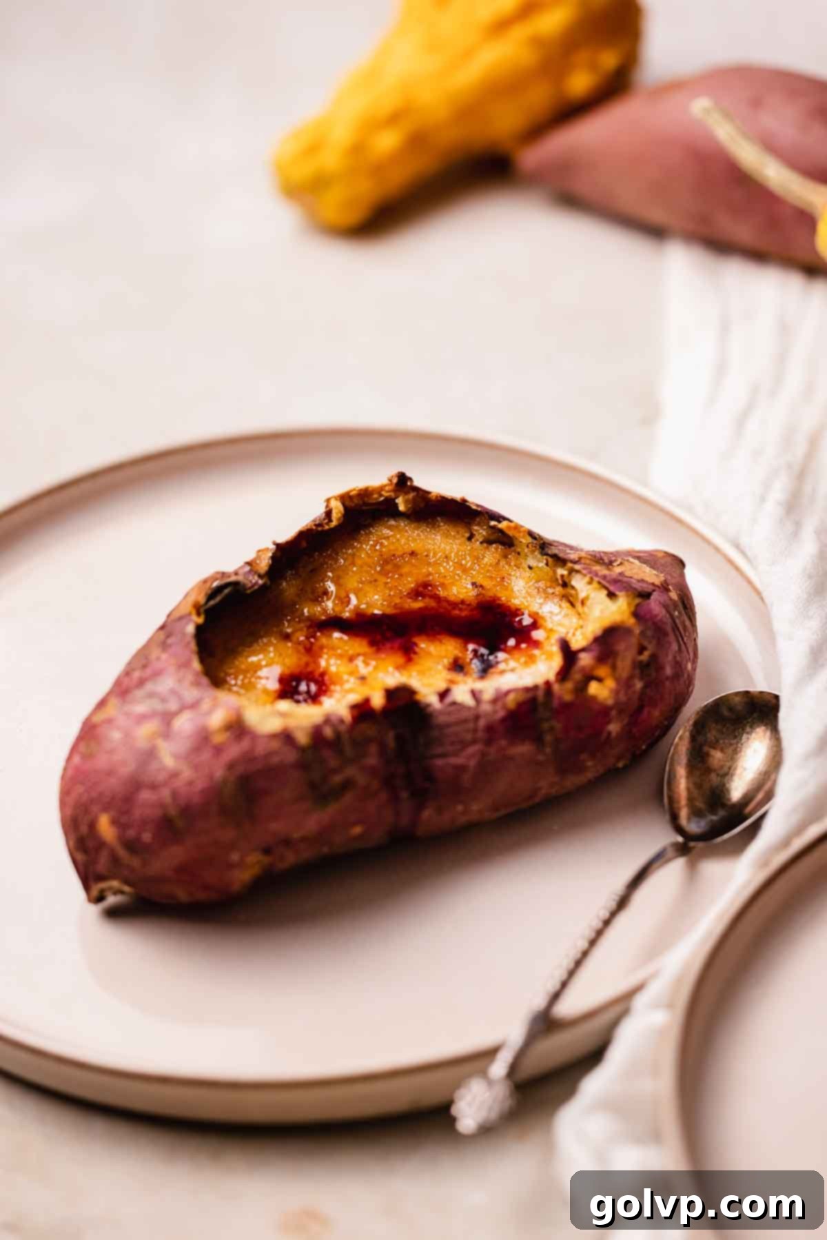A sweet potato crème brûlée served directly in its cooked sweet potato shell, highlighting its unique presentation.
