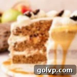 A slice of chai cake expertly cut to reveal its gooey spiced apple filling and tender cake layers, with a hint of caramel drizzle.