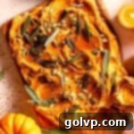 Pumpkin-infused butter artfully spread on a board, garnished with vibrant green sage leaves and decorative mini pumpkins, creating a beautiful fall display.