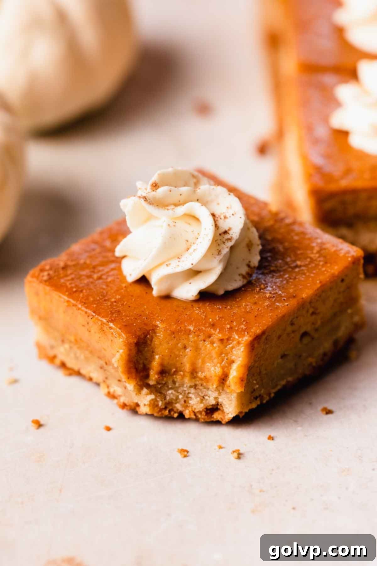 bitten pumpkin pie bar showing creamy filling and shortbread crust