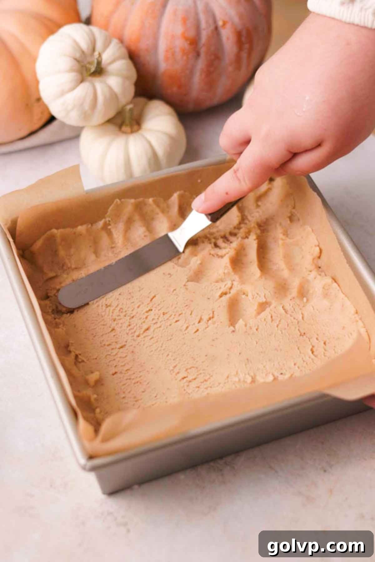 spreading shortbread pie crust into a baking pan