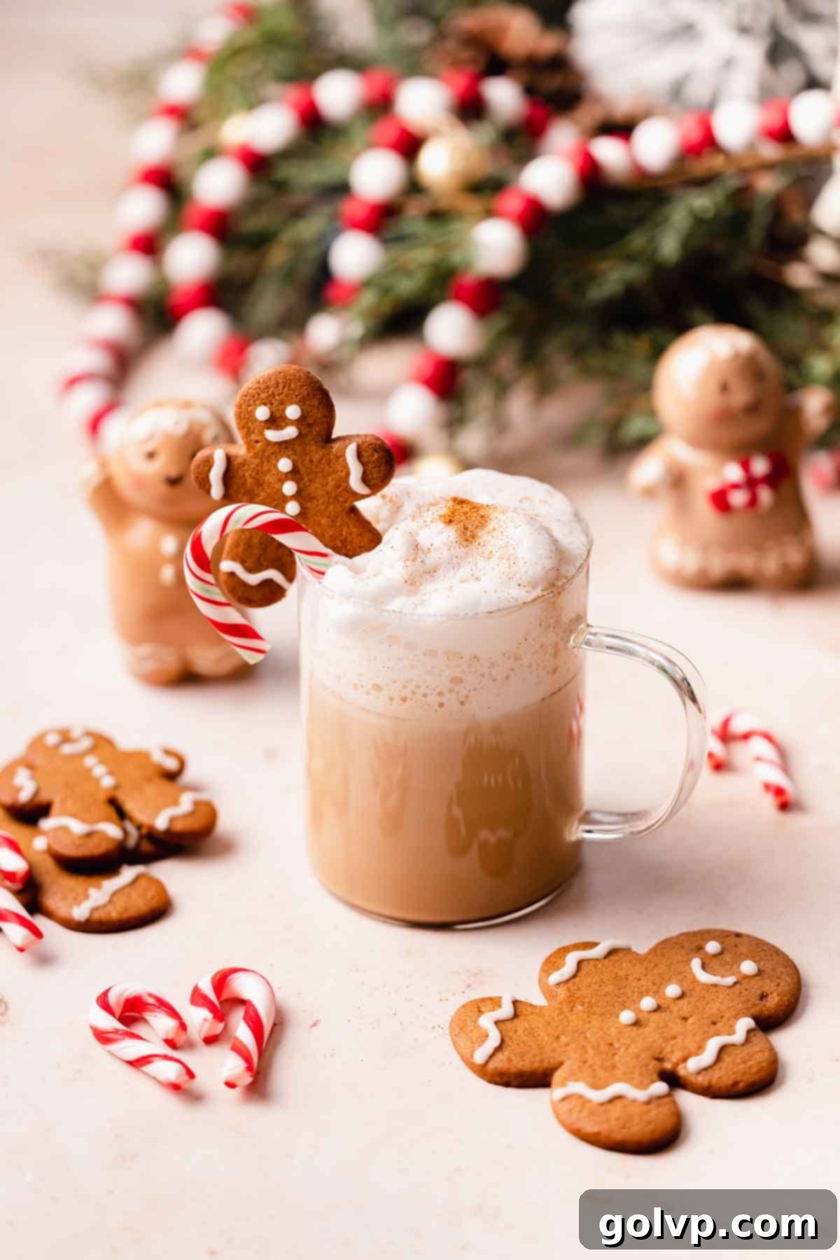 Festive gingerbread latte adorned with a candy cane and gingerbread cookies, perfect for the holidays