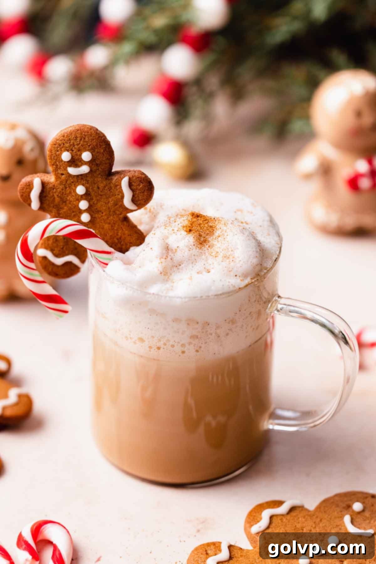 Close-up view of a creamy gingerbread latte in a glass mug, ready to be enjoyed