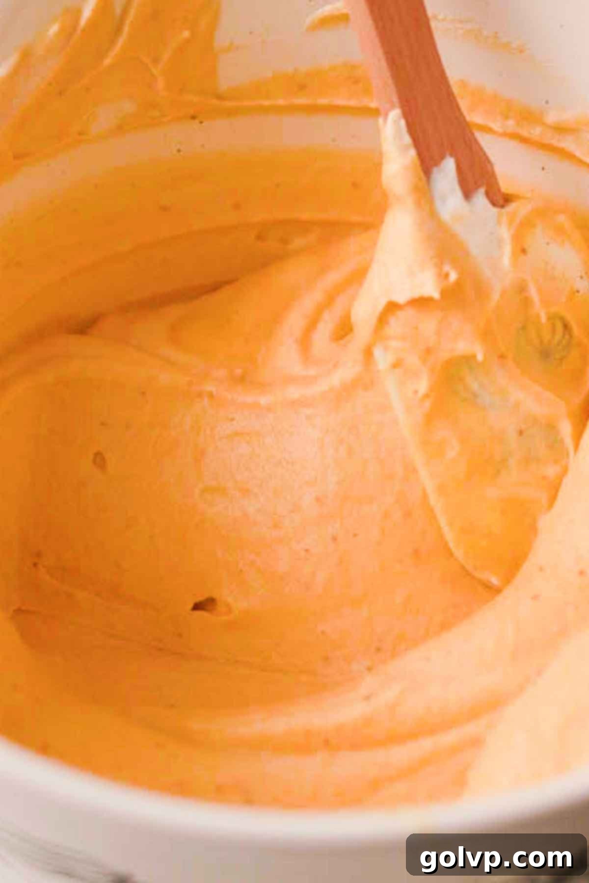 Folding pumpkin puree and pumpkin spice flavoring into the tiramisu mixture