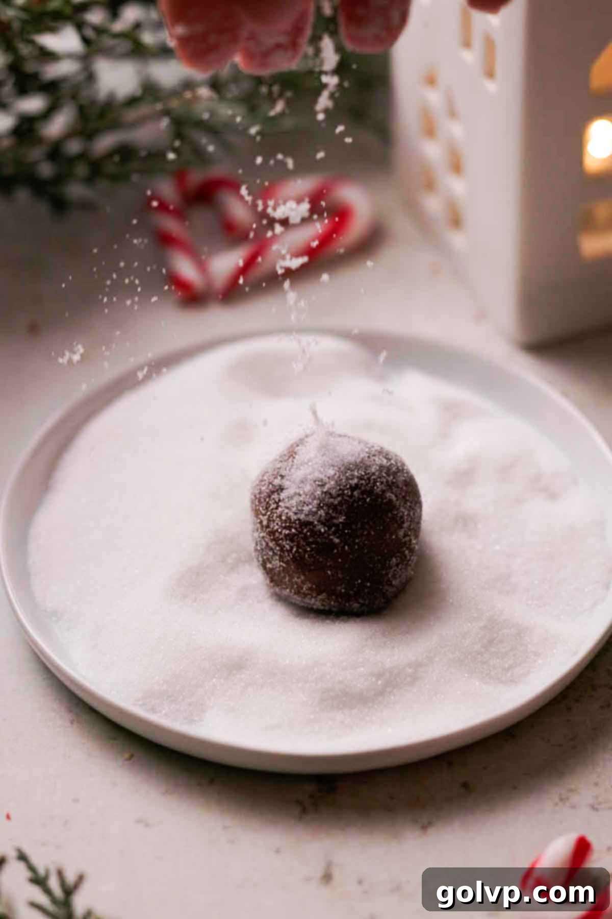 rolling chocolate cookie dough in sugar