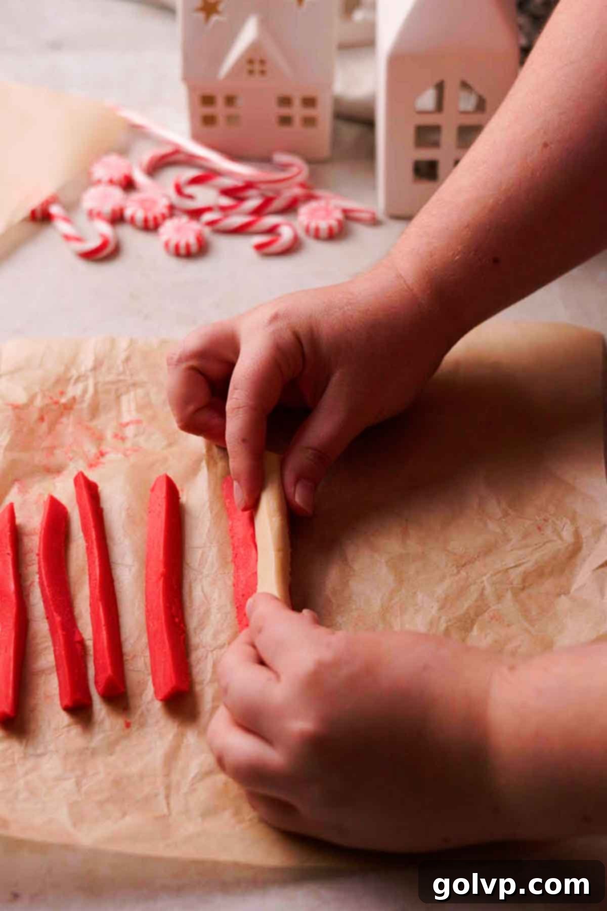 pressing red and white wedges together to form peppermint log