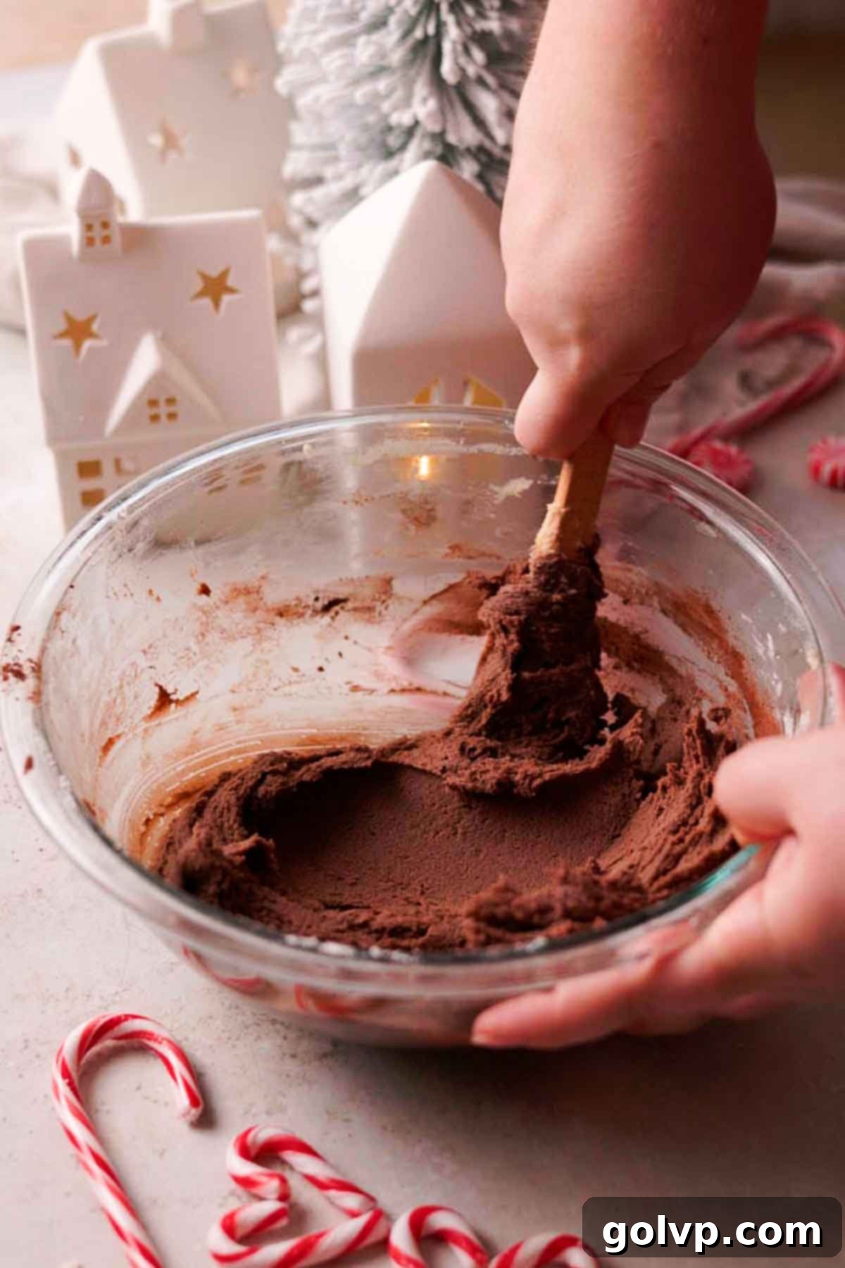 folding cocoa powder into dough to make chocolate base