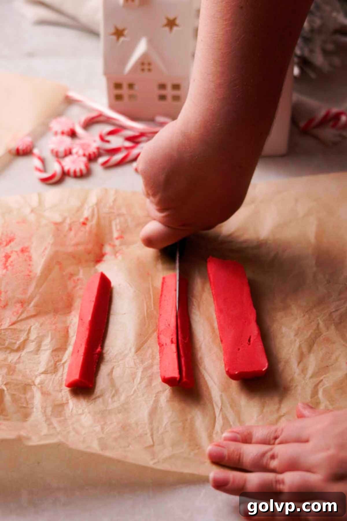 cutting red dough into wedges for peppermint pattern