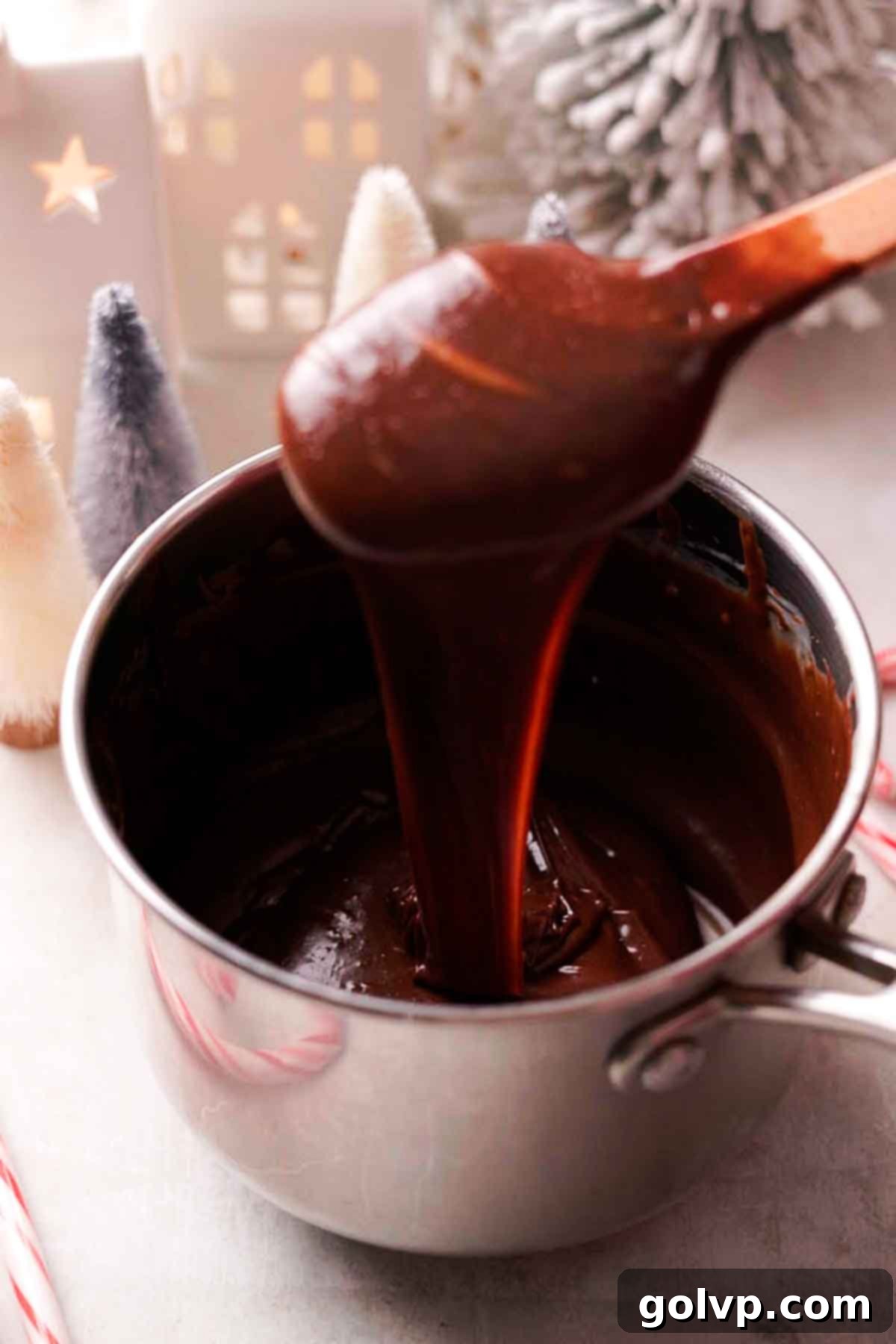 Indulgent Peppermint Fudge 5 Melted semisweet chocolate mixture for peppermint fudge in a saucepan, showing its smooth, glossy texture.