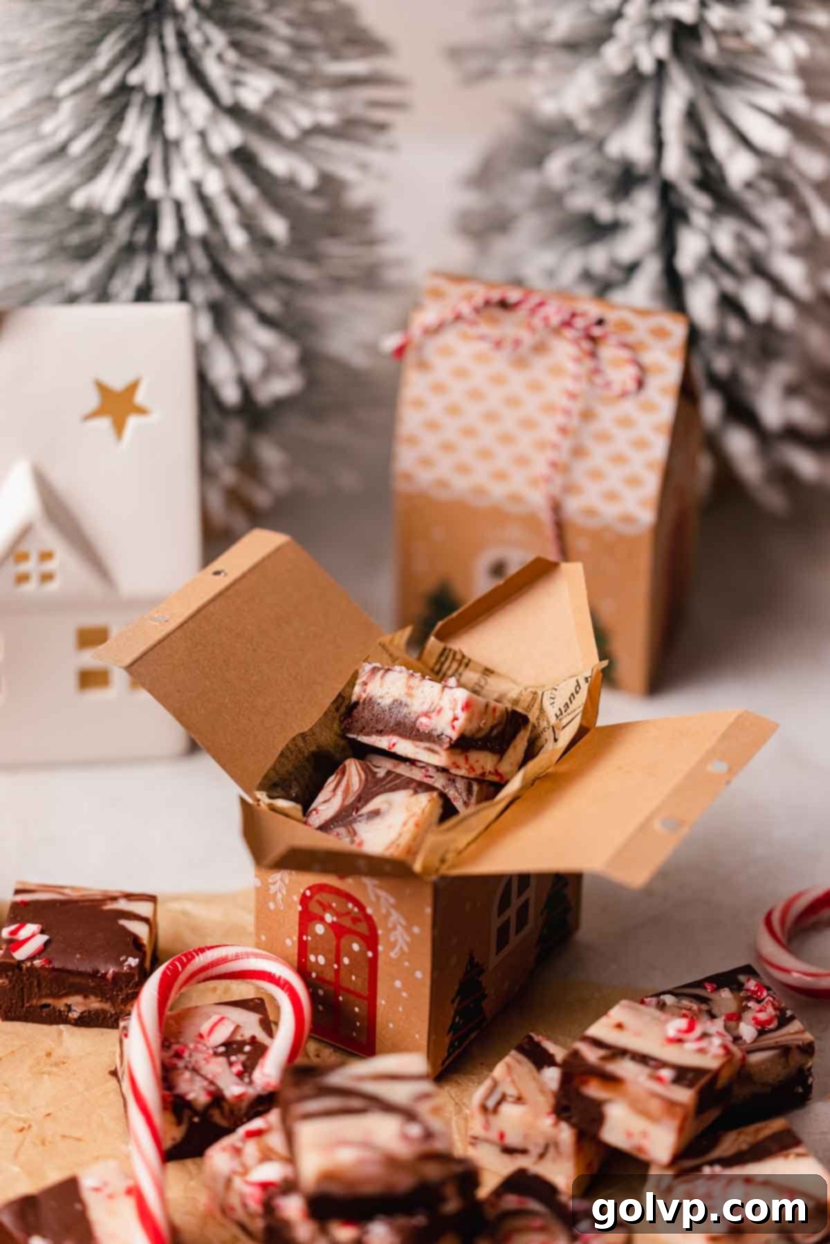 Indulgent Peppermint Fudge 10 Peppermint fudge neatly packed inside a charming gingerbread house-shaped gift box, lined with parchment paper.