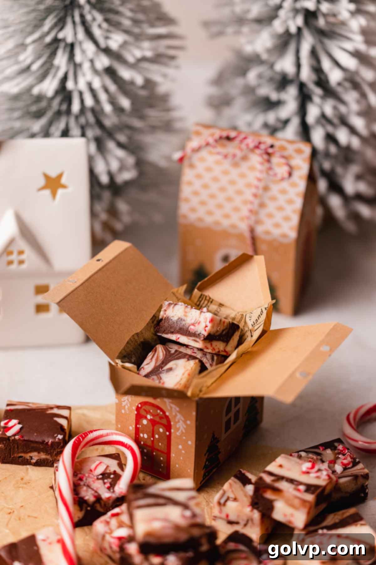 peppermint fudge packed away in a box that looks like a gingerbread house, ready for gifting