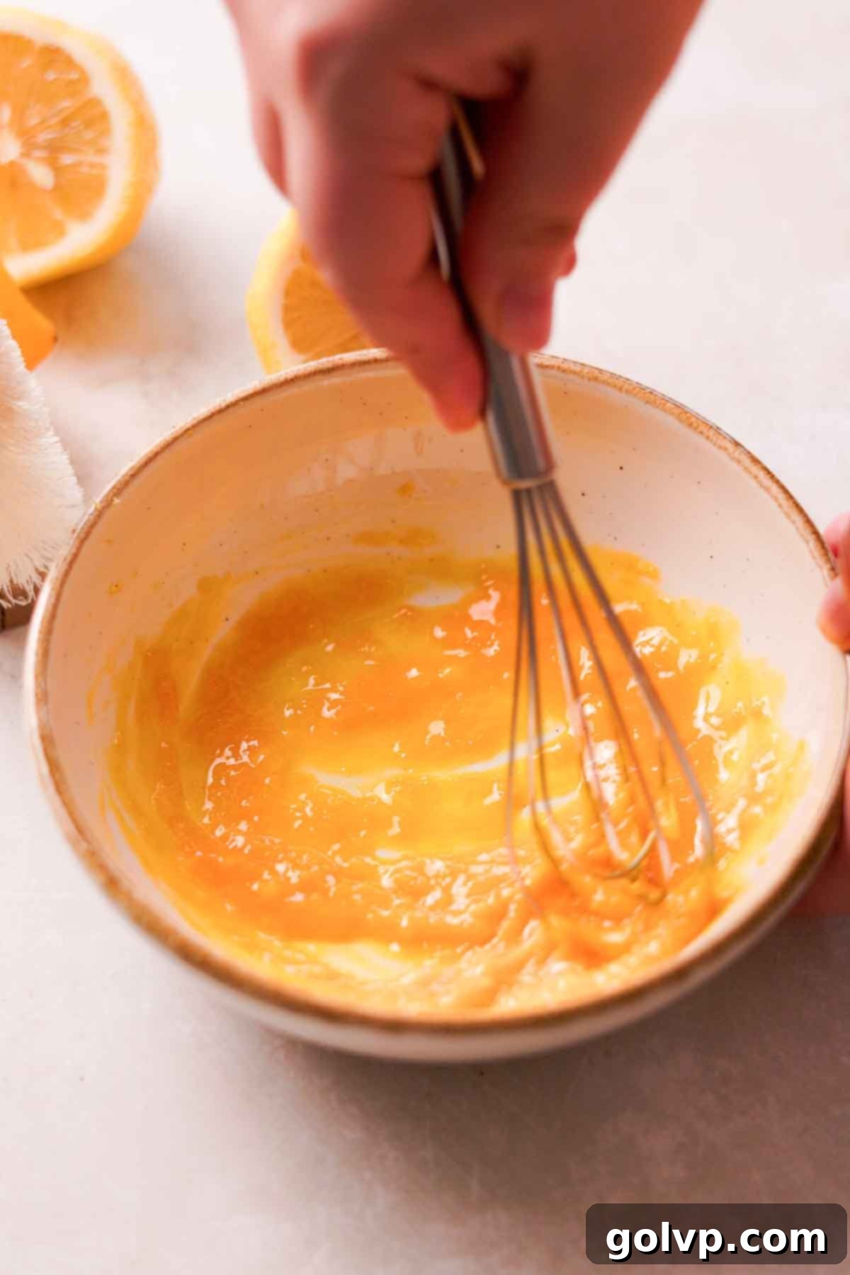 Zesty Meringue White Hot Cocoa Dream 6 whisking egg yolk and lemon zest in bowl