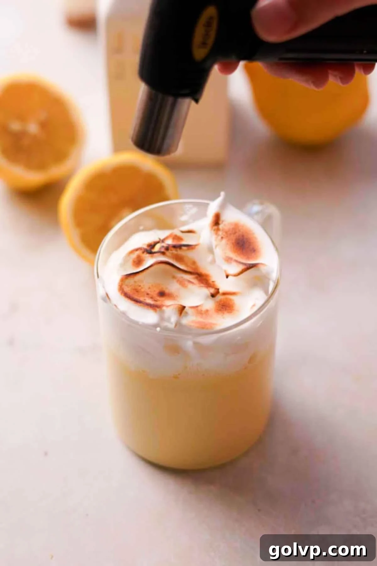 Zesty Meringue White Hot Cocoa Dream 9 torching meringue topping with a kitchen torch until toasted