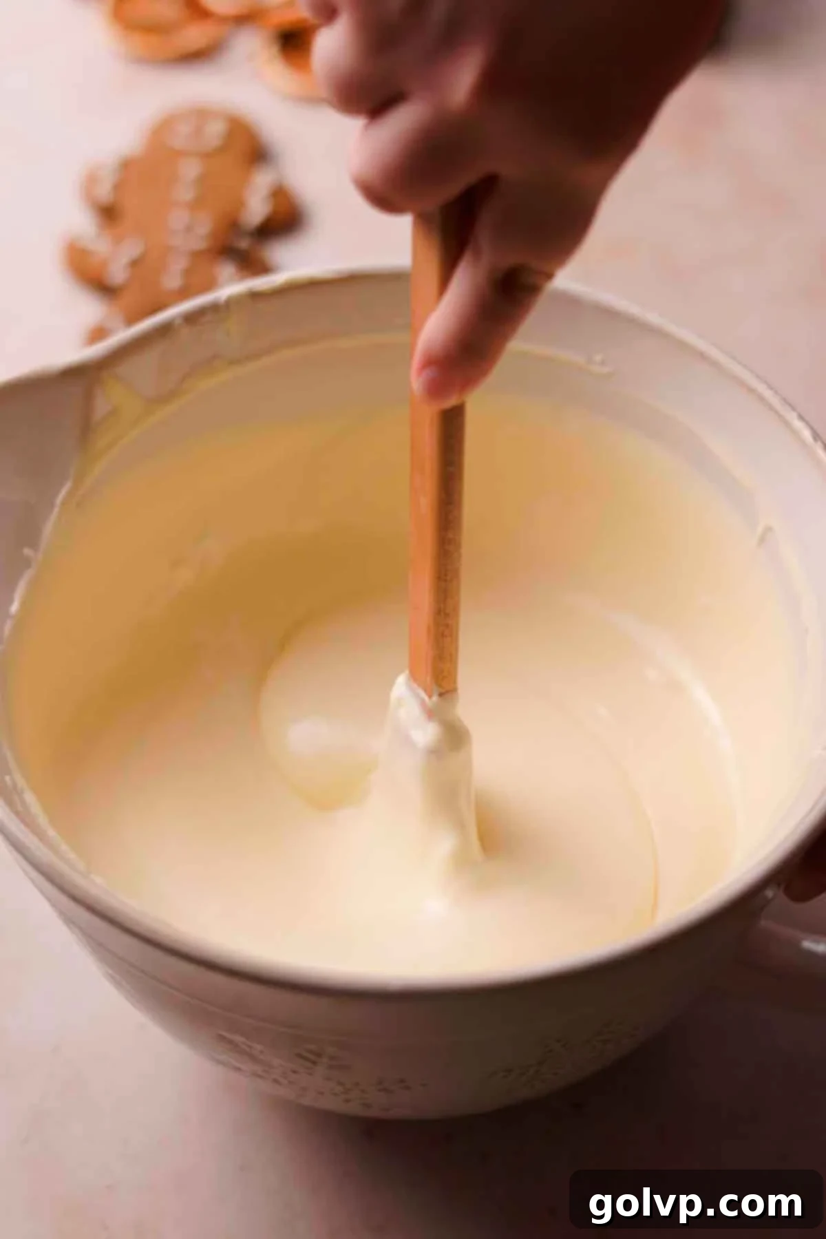 mixing gingerbread cheesecake batter