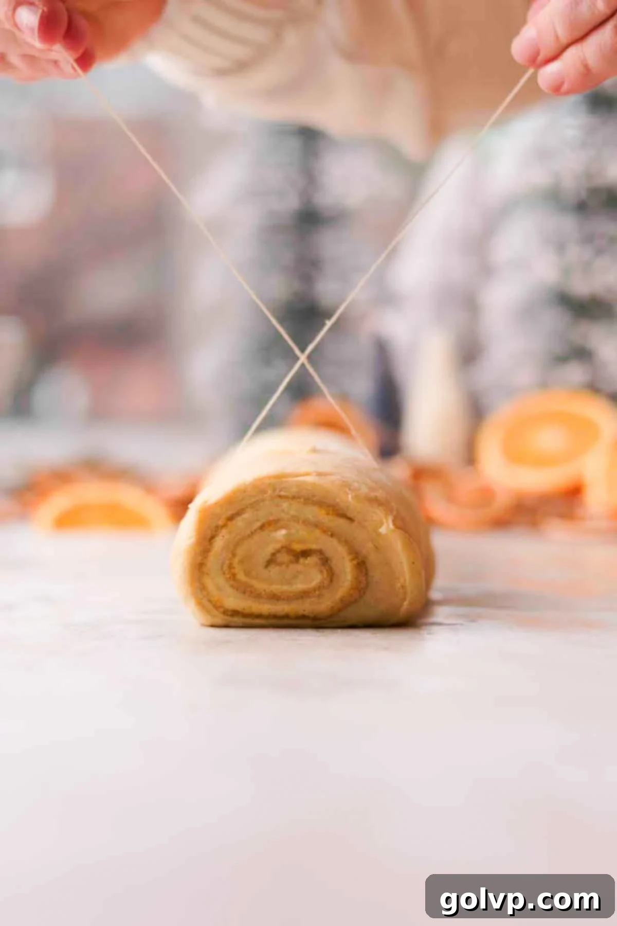 cutting orange cinnamon rolls with string