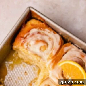 tray of orange cinnamon rolls with 1 missing