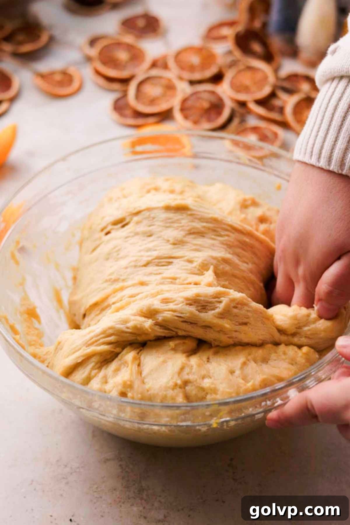 pulling the edges and bringing it over the dough