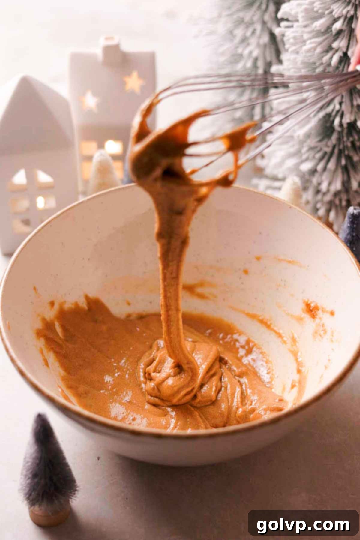 whisking egg and sugars until thick and ribbon like
