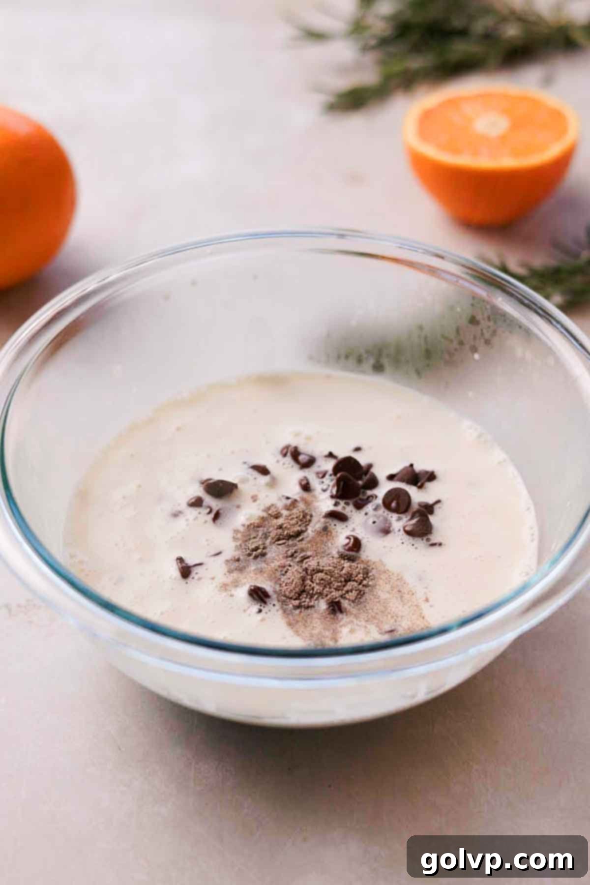 covering chocolate chips with hot cream for ganache