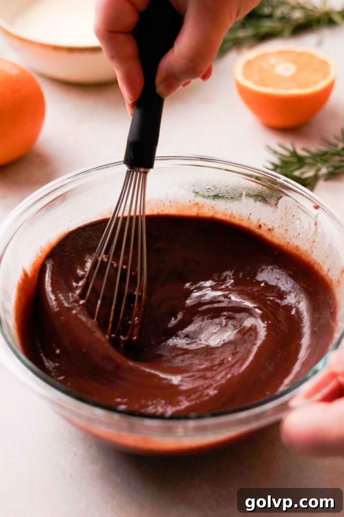 whisking together chocolate cardamom ganache until smooth
