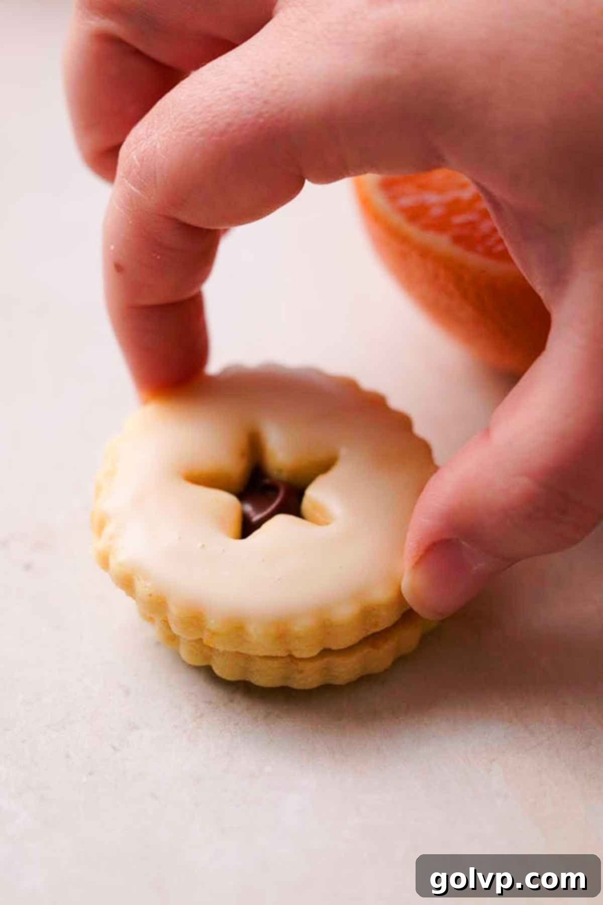 stacking two shortbread cookies to make a sandwich cookie