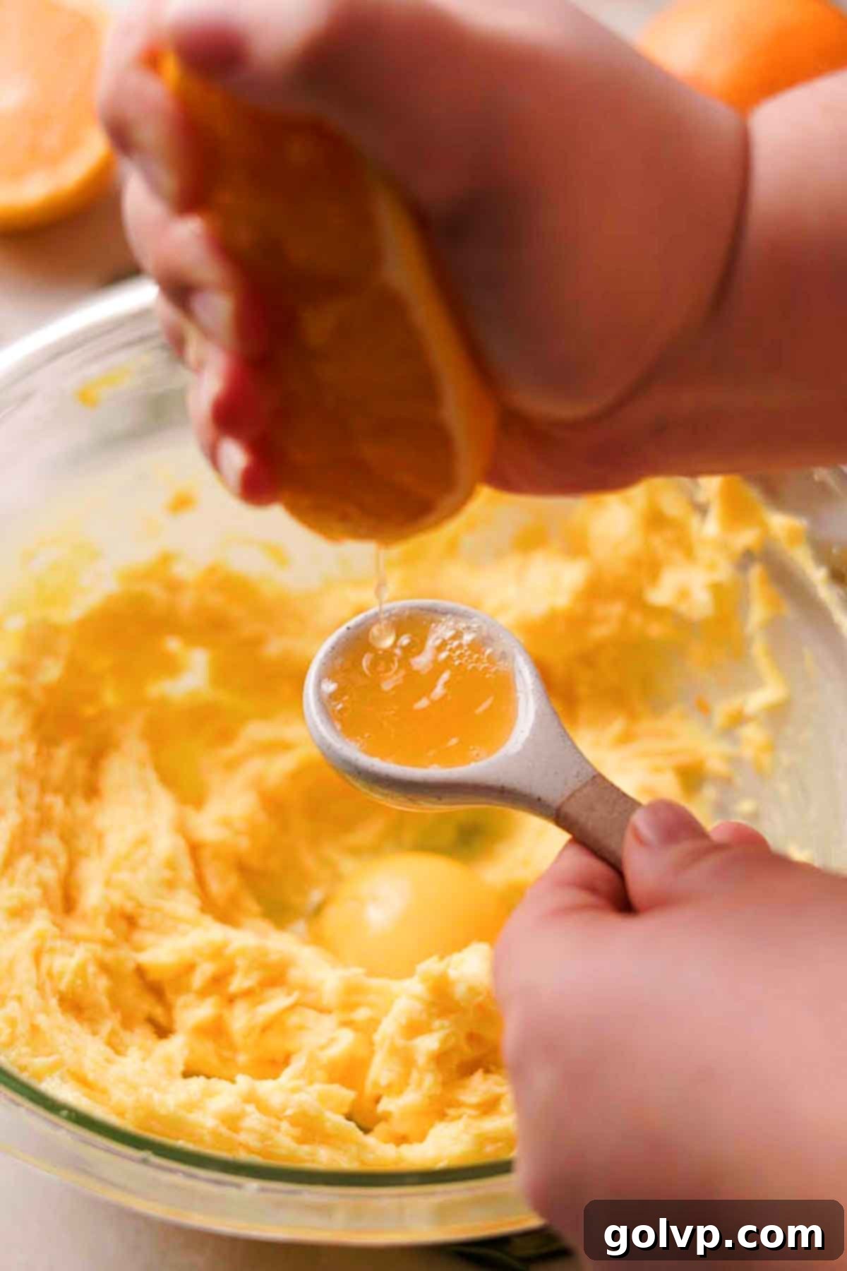 add egg yolk, orange juice, and vanilla extract to orange shortbread cookie dough