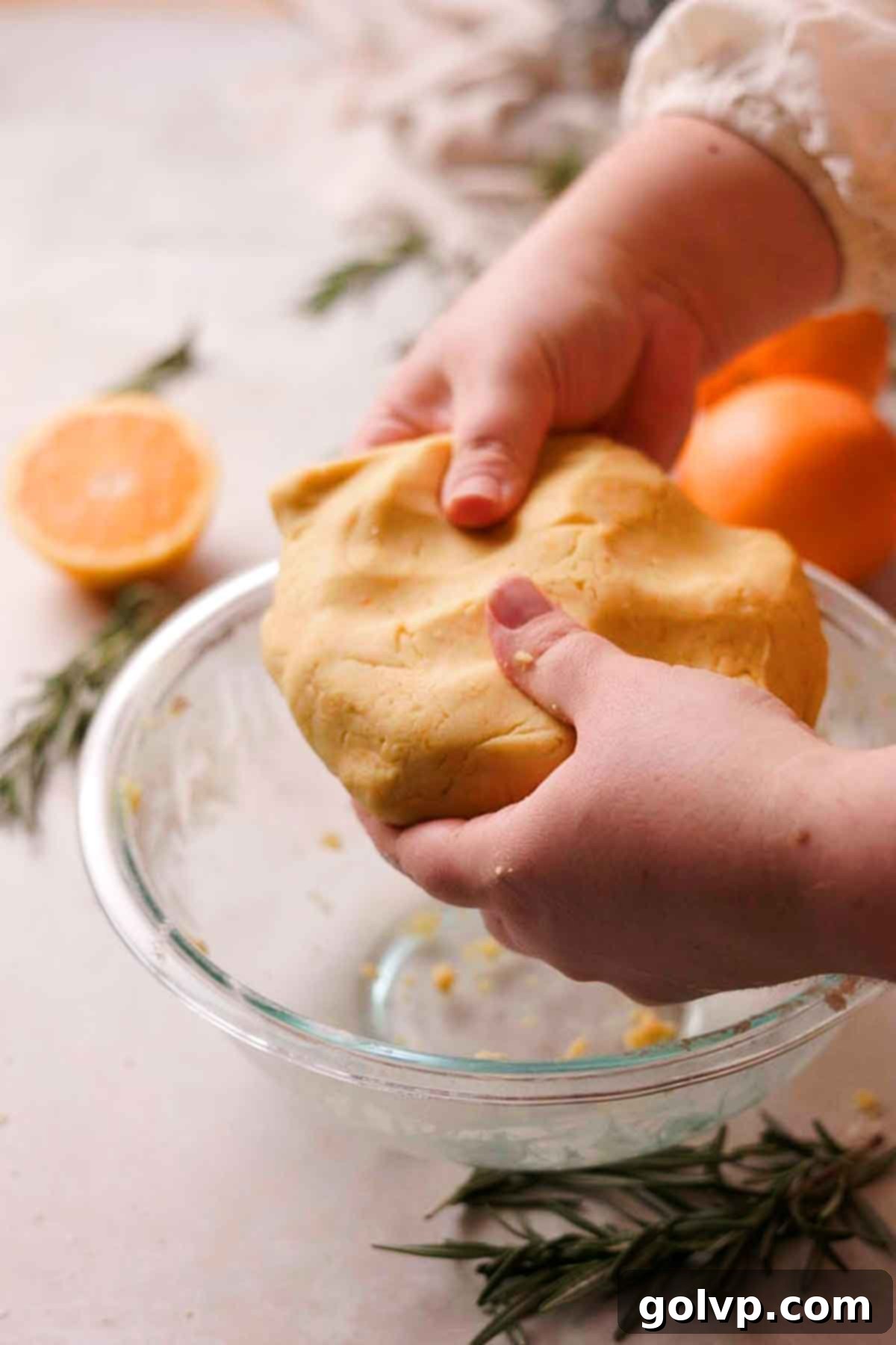 mixing orange shortbread cookie dough with sifted flour