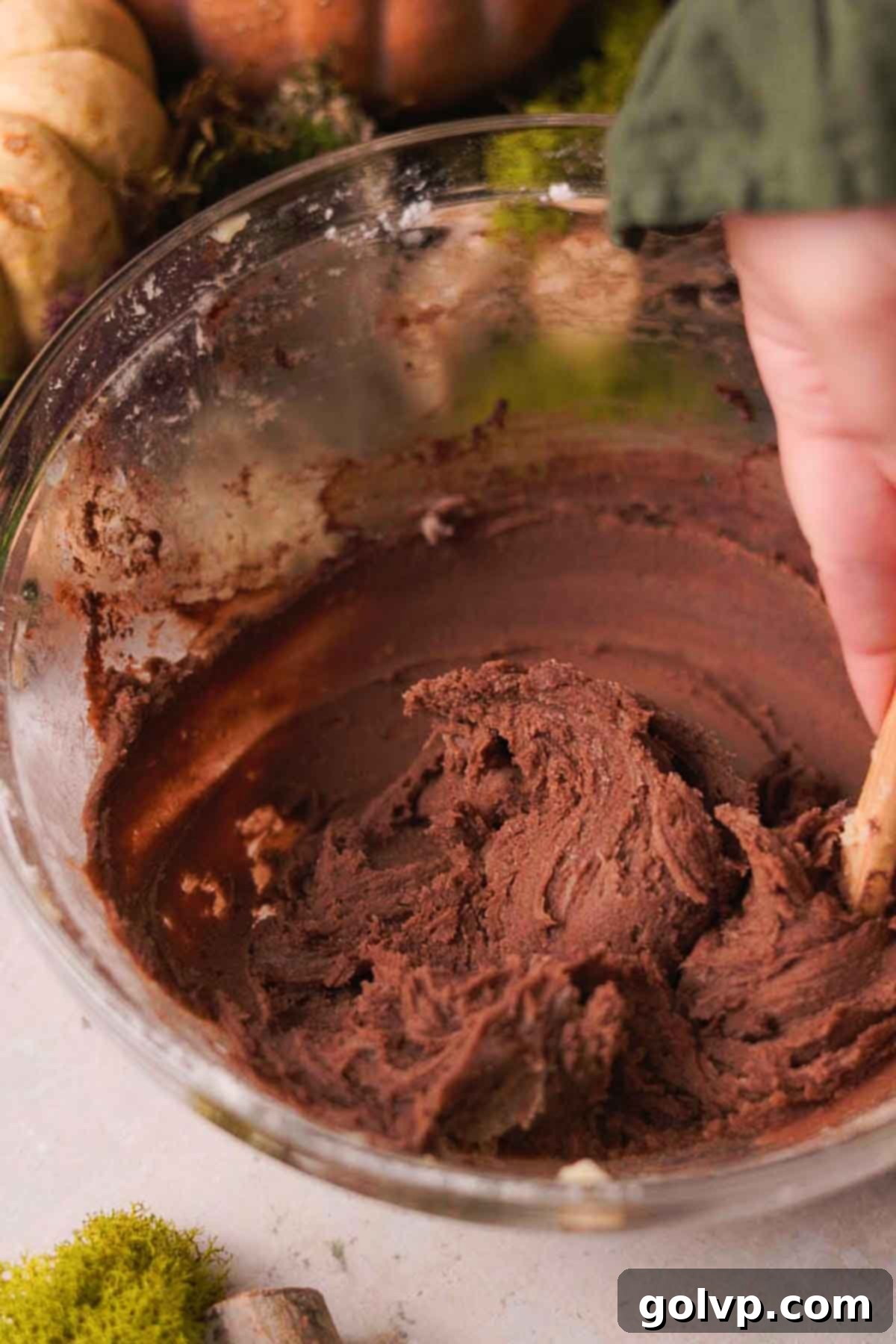 mixing cocoa powder into the remaining larger portion of dough