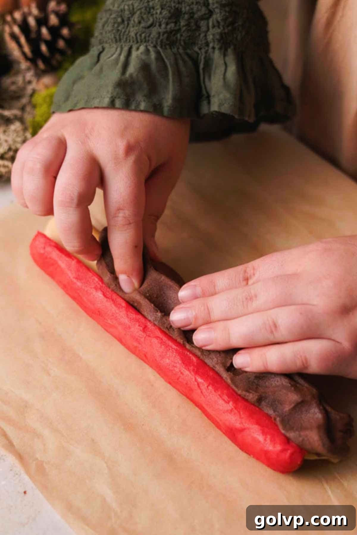 wrapping chocolate dough around the formed mushroom parts to create a log