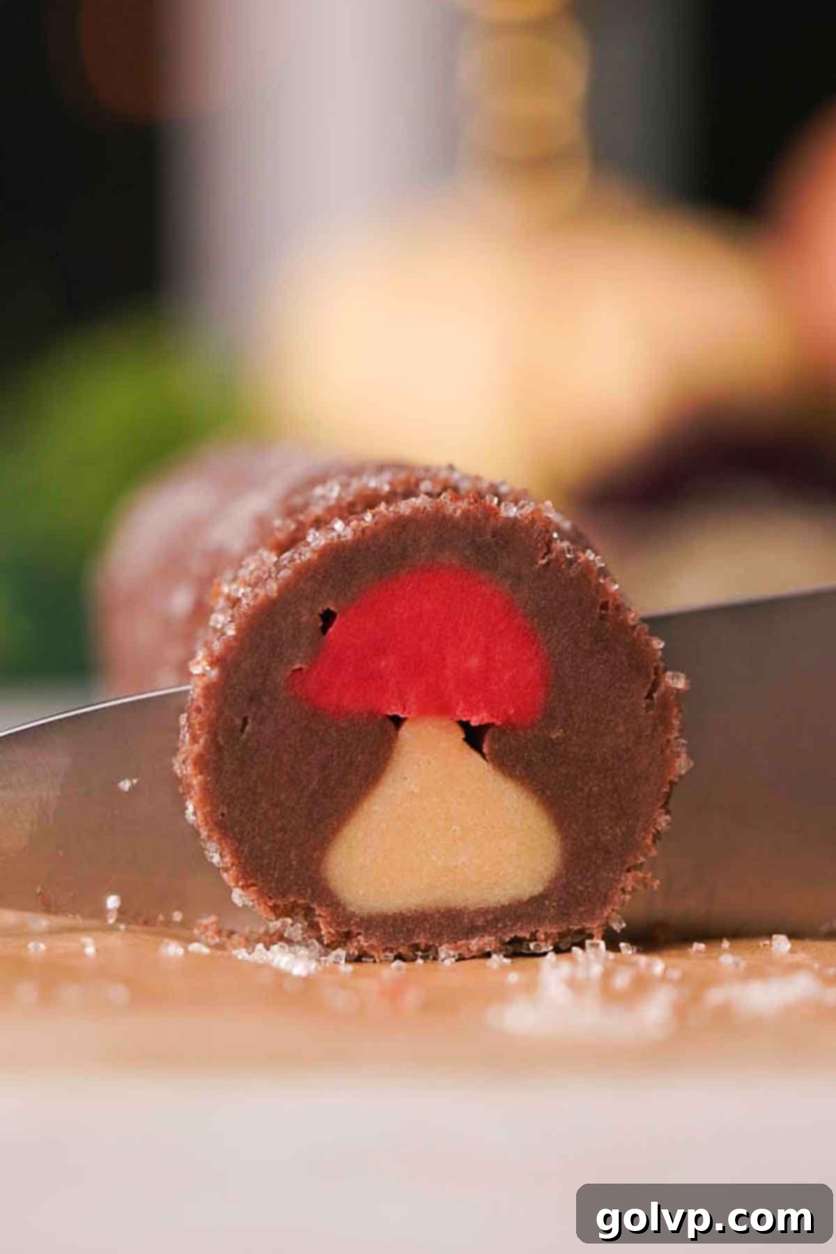 slicing the chilled mushroom sugar cookie dough log with a sharp knife