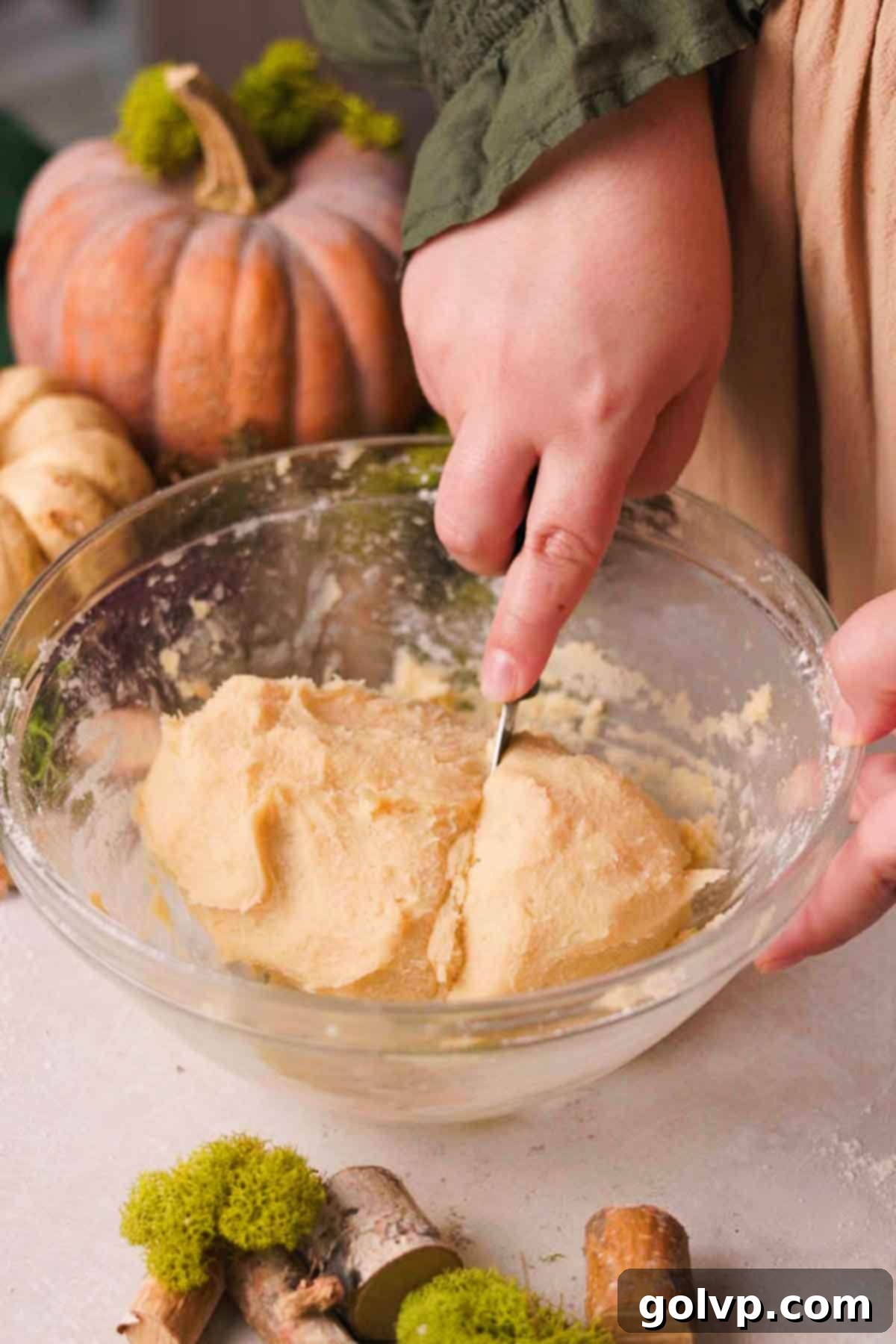 cutting off one third of the cookie dough log for the mushroom design