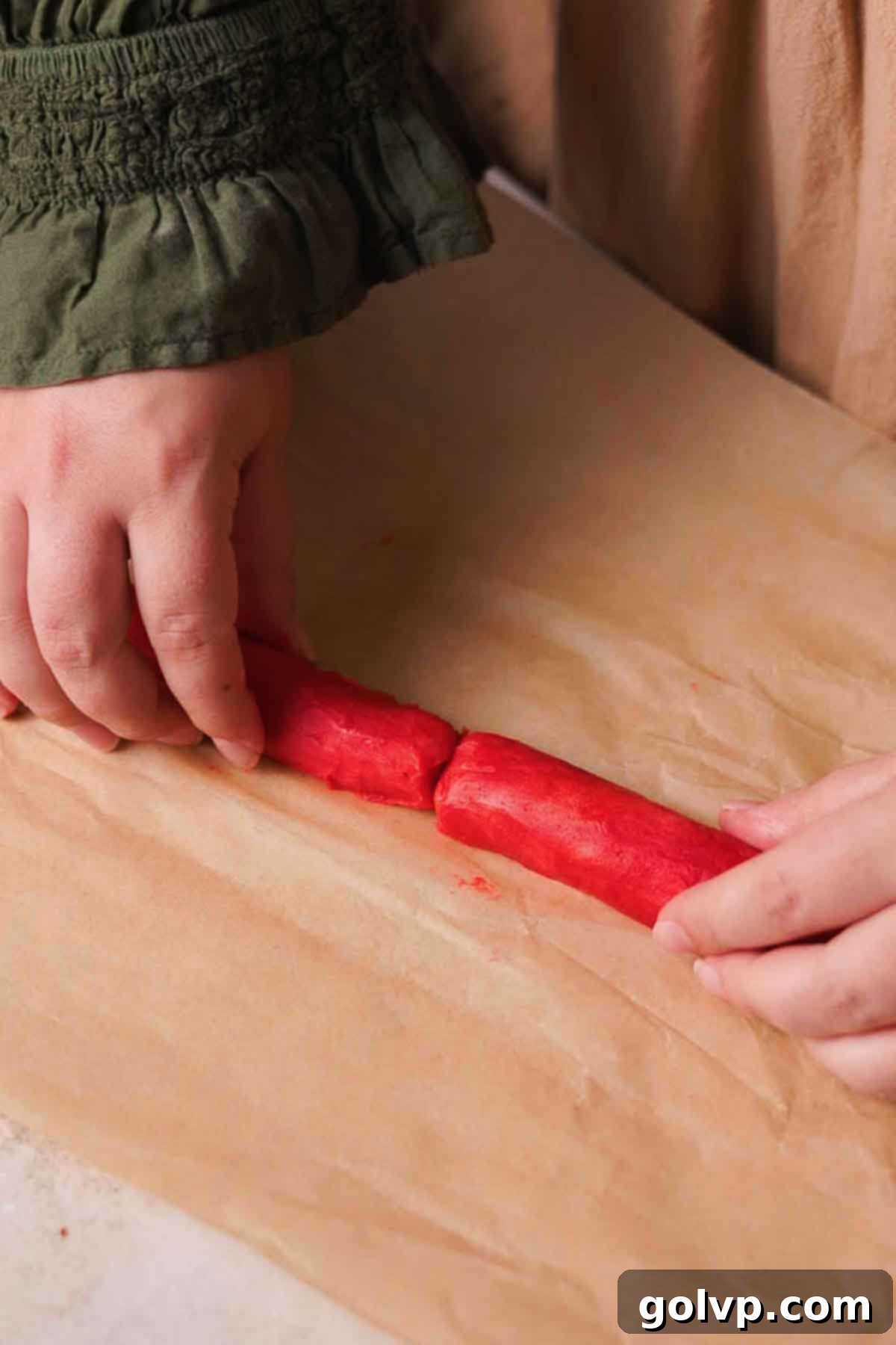 joining two halves of the red dough log into one piece