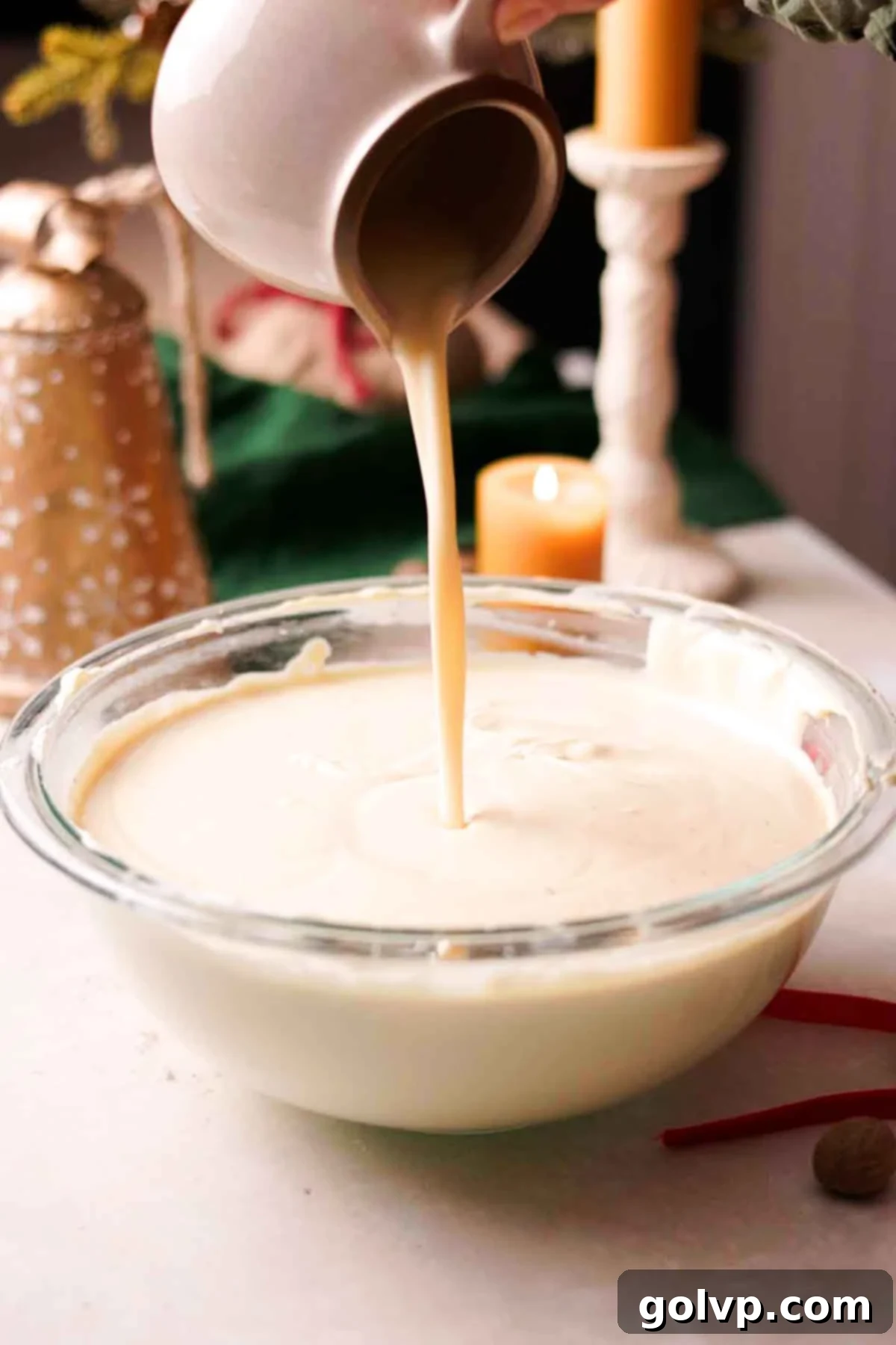 Decadent Holiday Eggnog Cheesecake 7 pouring eggnog into batter