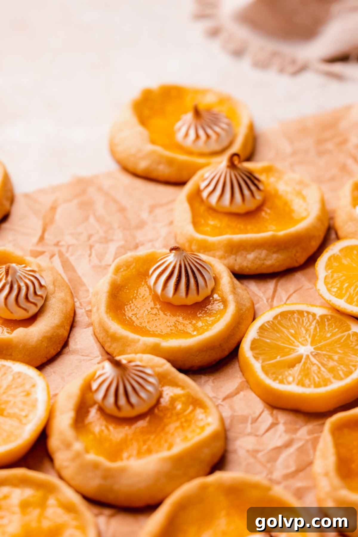 shortbread cookies with lemon filling and dollops of toasted meringue, arranged beautifully on a baking sheet