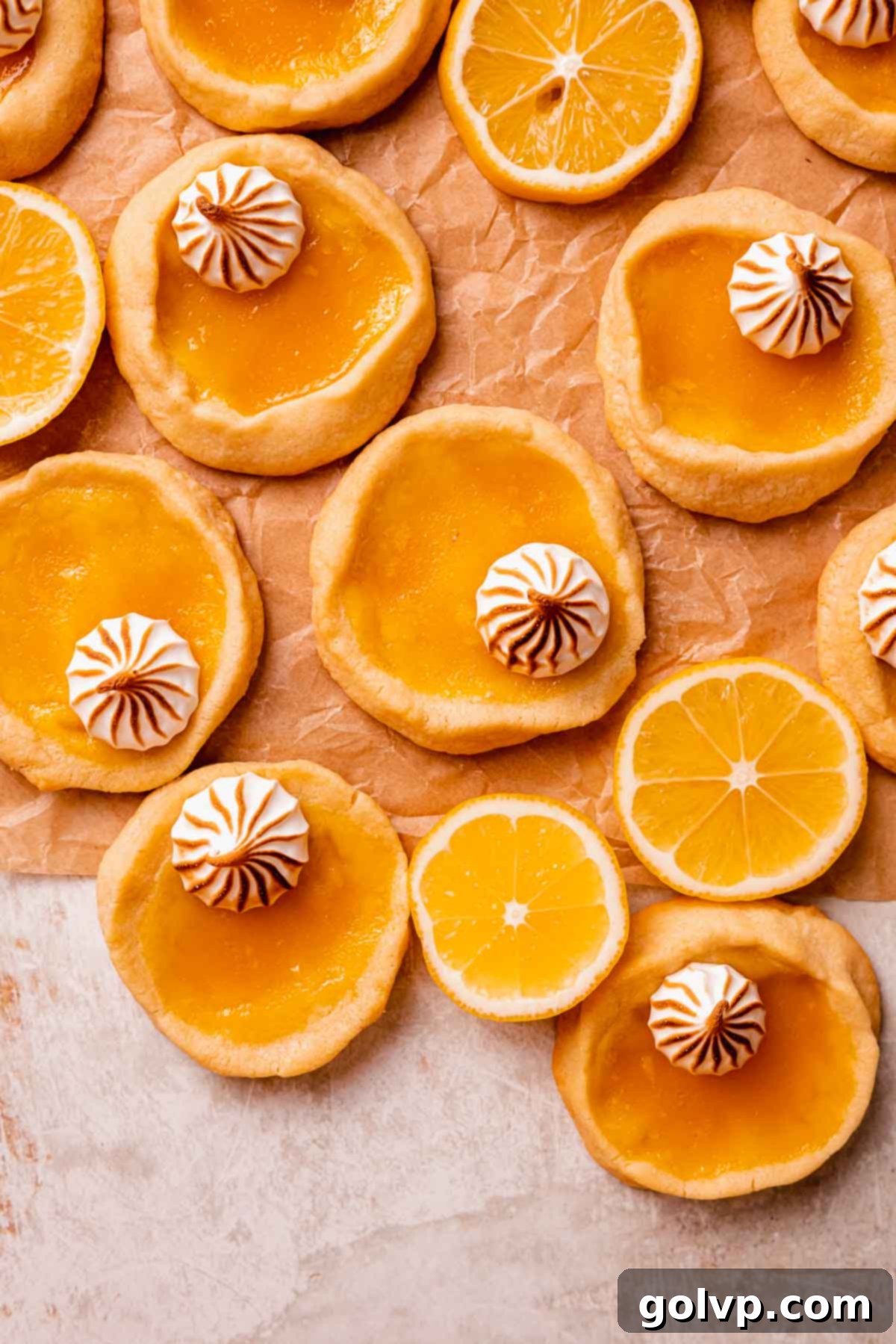 A tray of freshly baked lemon filled cookies topped with elegant dollops of toasted meringue, ready to be served