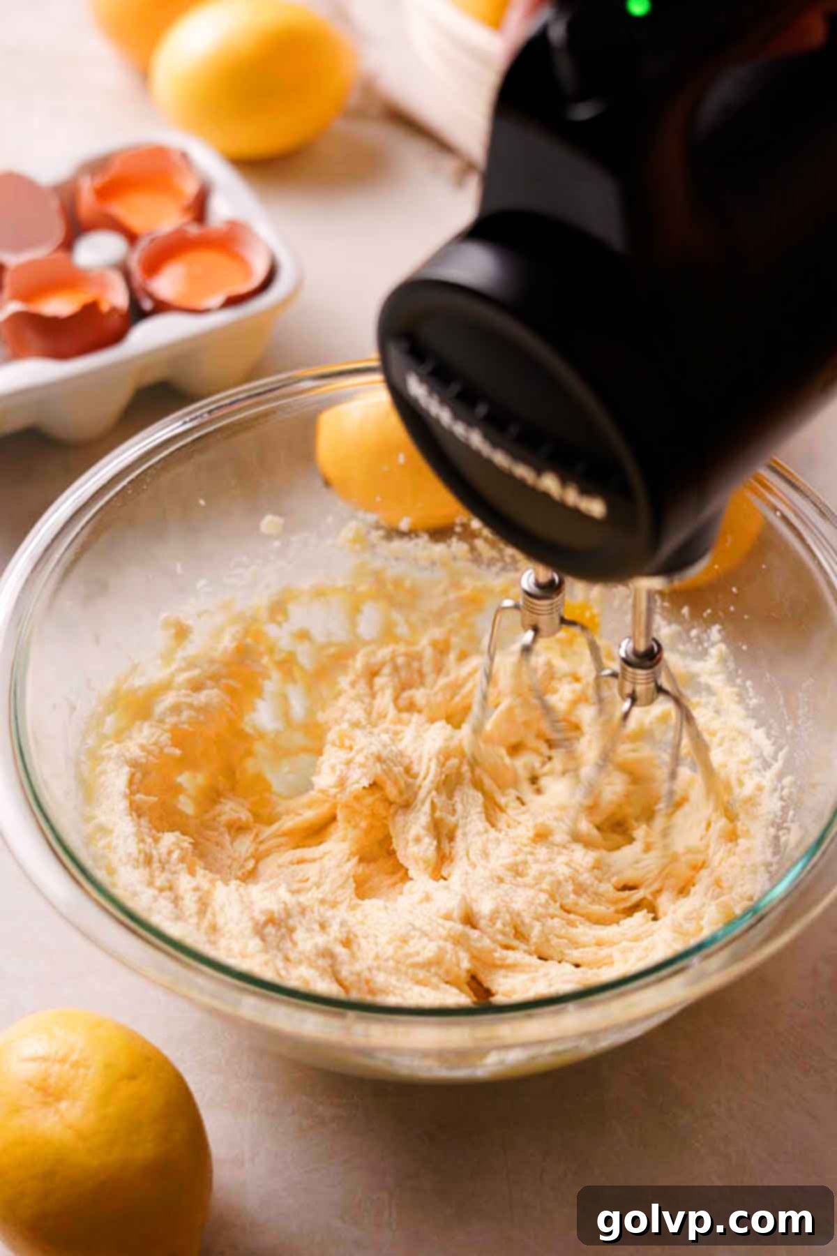 Creaming together softened butter, lemon-infused sugar, and egg yolk in a stand mixer for lemon shortbread dough
