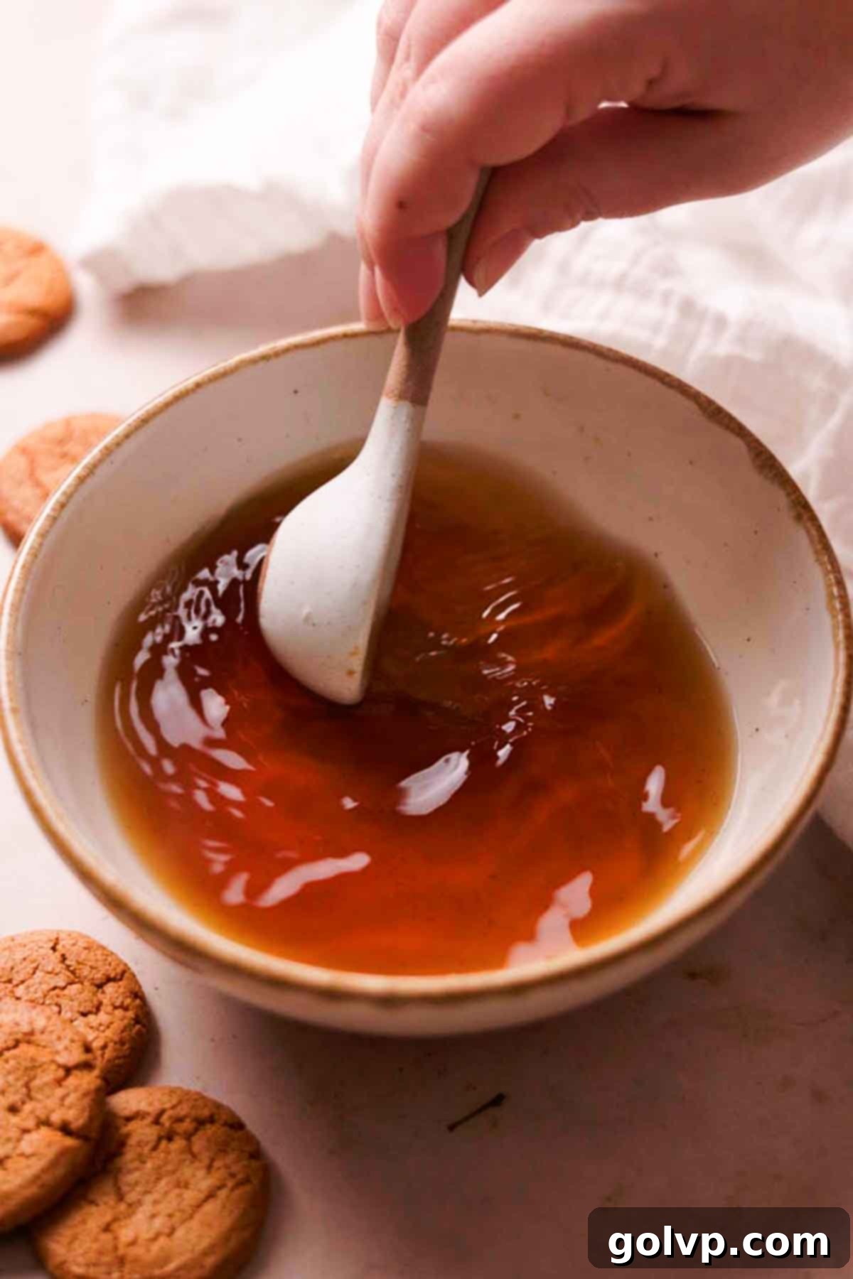 stirring together hot water and brown sugar in bowl