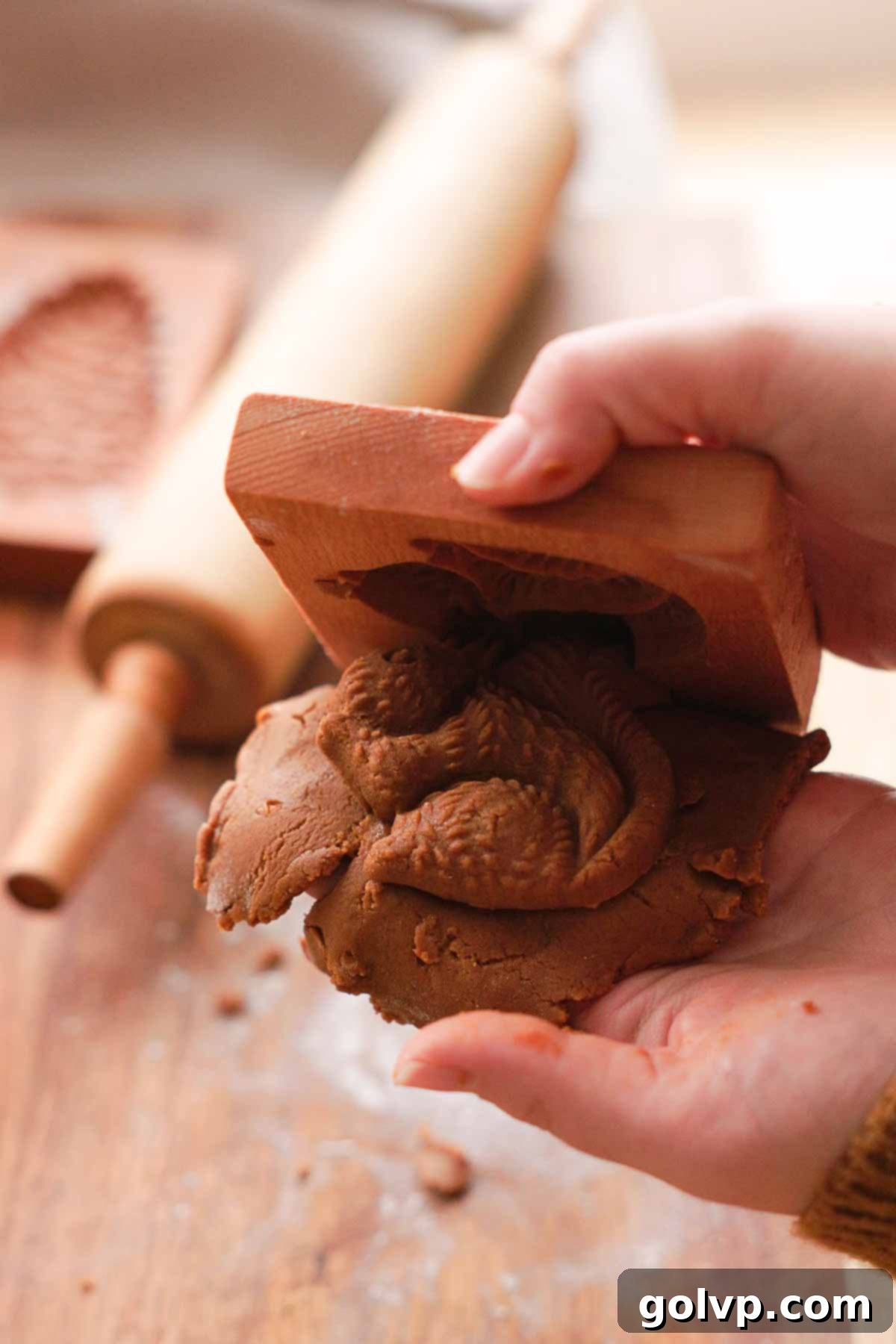unmolding gingerbread cookie dough out of cookie mold gently