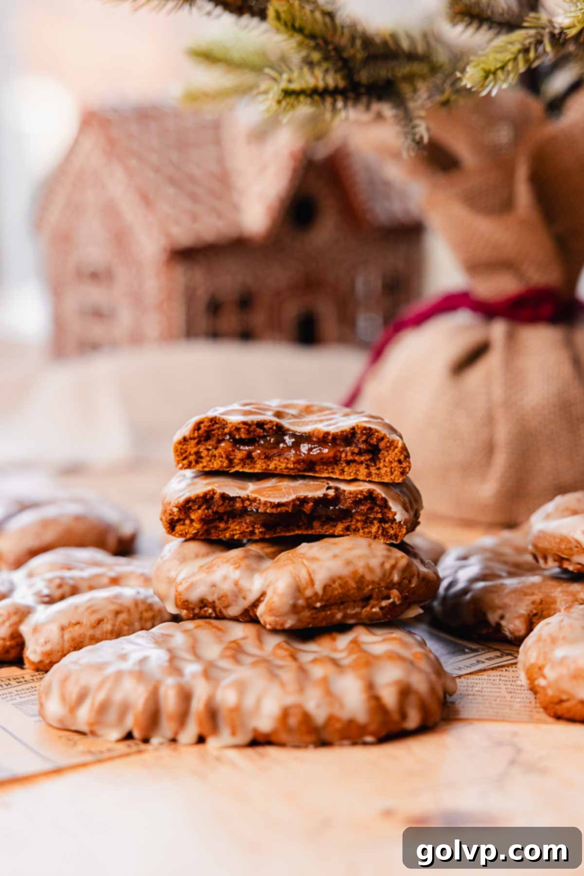 thick gingerbread cookies with jam filling and glaze stacked on top of eachother